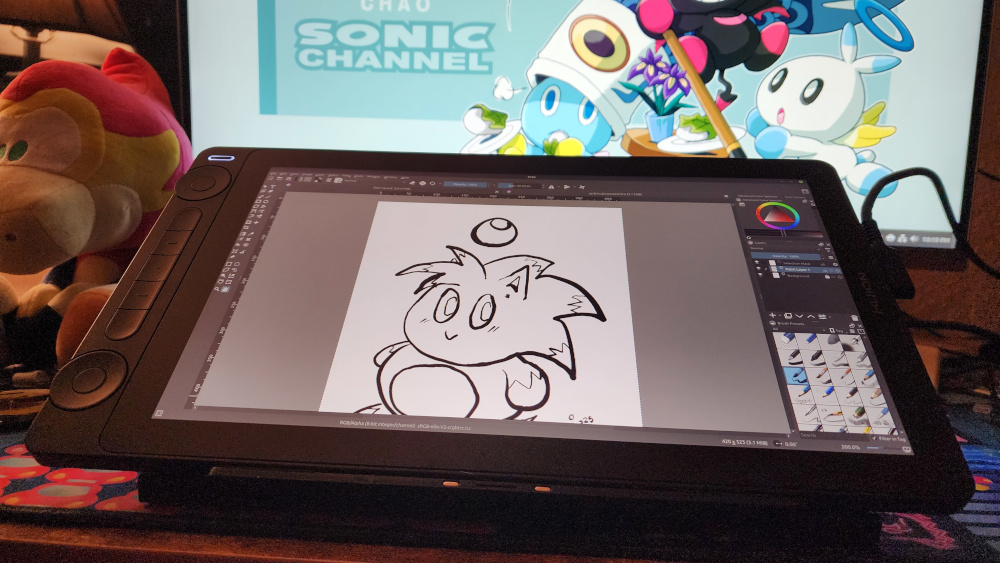 Photo of desktop workspace, featuring the Huion Kamvas 13 (Gen 3) pen display tablet from Huion.